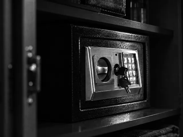 Small keypad safe with override key on a bookshelf in a Vancouver home